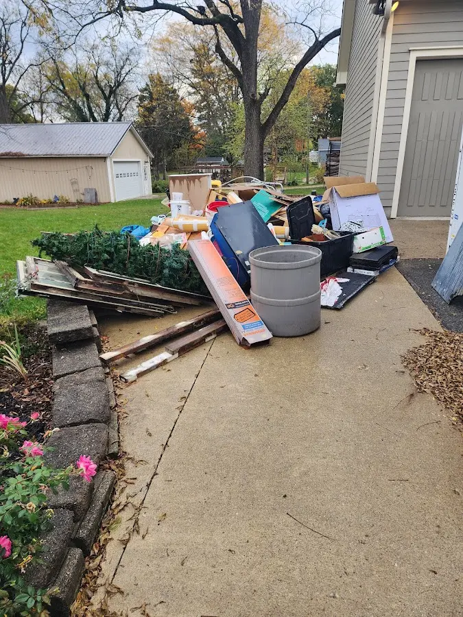 Dumpster being loaded with debris for 3 Yard Dumpster Rental in Bear Creek